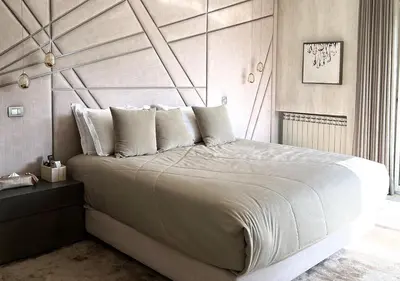 a bedroom with a large bed with a wooden headboard at Villa de luxe avec piscine privée au cœur de Casablanca, Maroc in Casablanca