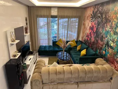 a living room with a couch and a large painting at SUPERBE STUDIO MEUBLE CASABLANCA in Casablanca
