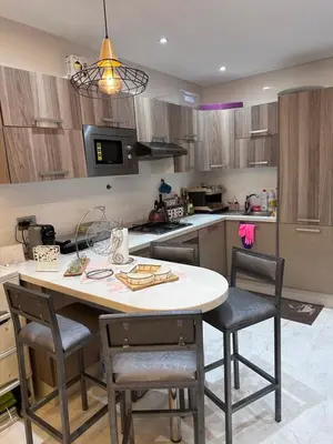 a kitchen with a table and chairs in a kitchen at SUPERBE STUDIO MEUBLE CASABLANCA in Casablanca