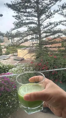 a person holding a glass of green drink at SUPERBE STUDIO MEUBLE CASABLANCA in Casablanca
