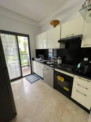 a kitchen with a stove and a large window at BM Resort in Casablanca