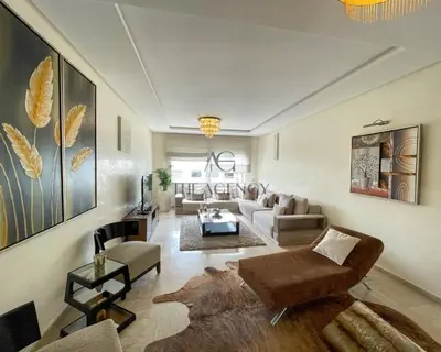 a living room with a couch and a table at Luxueux appartement Bay view dans une résidence avec magnifique jardin in Casablanca