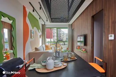 a kitchen with a table with a sink and a couch at Stayhere Casablanca - CFC - Vibrant Residence in Casablanca