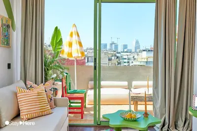 a living room with a couch and a view of a city at Stayhere Casablanca - CFC - Vibrant Residence in Casablanca