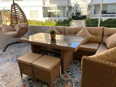 a patio with a couch and a table and chairs at Maison Bleu in Mansouria