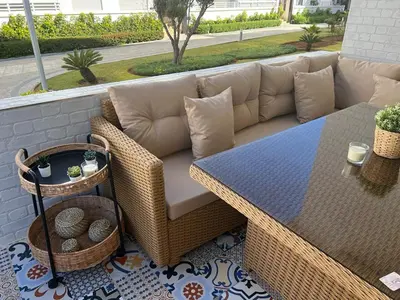 a wicker couch and a table on a patio at Maison Bleu in Mansouria