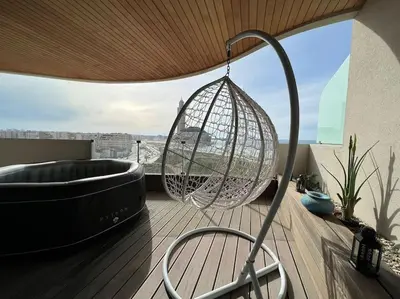 a hammock and a tub on a deck with a balcony at Marina Love in Casablanca