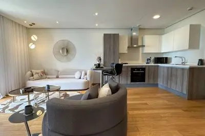 a living room with a couch and a kitchen at Marvelous Ocean View Suite Marina - By AppartAli in Casablanca