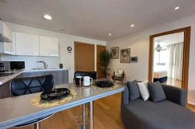 a kitchen and living room with a table and a couch at Marvelous Ocean View Suite Marina - By AppartAli in Casablanca