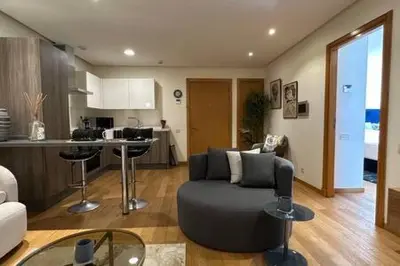 a living room with a couch and a kitchen at Marvelous Ocean View Suite Marina - By AppartAli in Casablanca