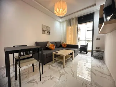 a living room with a couch and a table at Appartement BMK N-1 in Rabat