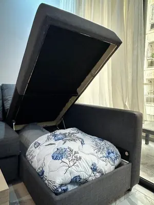 a bed with a cover on top of it at Appartement BMK N-1 in Rabat