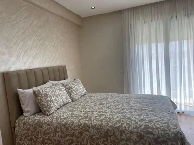 a bedroom with a bed and a large window at Studio meublé neuf à louer in Casablanca