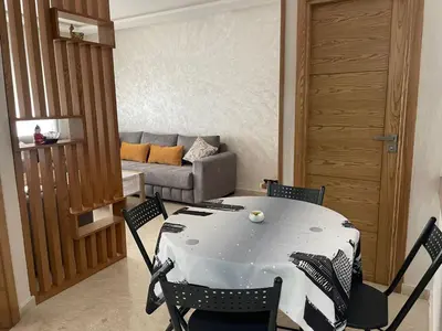a living room with a table and chairs and a couch at Studio meublé neuf à louer in Casablanca