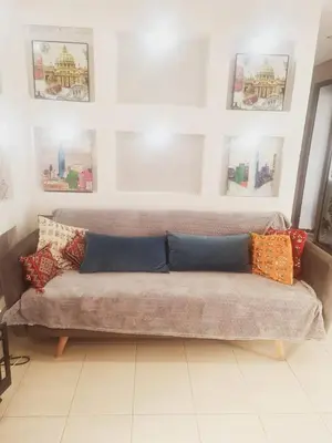 a couch with pillows on it in a living room at Residence Puerto Banus in Mohammedia