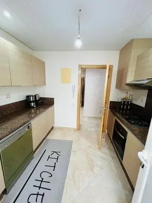 a kitchen with a sign on the floor of a kitchen at superbe appartement en résidence balnéaire in Bouznika