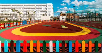 a colorful basketball court in front of a fence at superbe appartement en résidence balnéaire in Bouznika