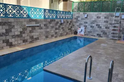 a large swimming pool with a tile wall at Villa Jack Beach in Tamaris