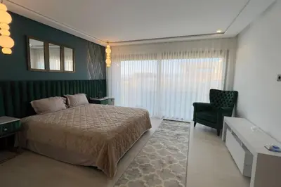 a bedroom with a bed and a desk and a chair at Villa Jack Beach in Tamaris