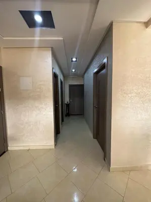 a hallway of a building with doors and a tile floor at Appartement vue sur mer sidi Rahal in Sidi Rahal