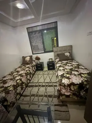 a bedroom with two beds and a window in it at Appartement vue sur mer sidi Rahal in Sidi Rahal