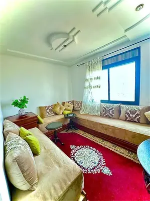 a living room with a couch and a window at Appartement vue sur mer sidi Rahal in Sidi Rahal