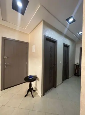 a room with two doors and a table in it at Appartement vue sur mer sidi Rahal in Sidi Rahal
