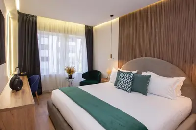 a hotel room with a large bed and a window at Le M Hôtel in Rabat