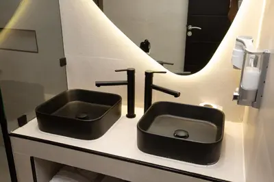 a bathroom with a black sink and a mirror at Le M Hôtel in Rabat