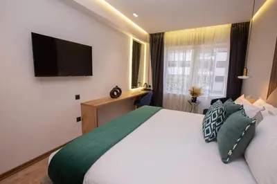 a bedroom with a large bed with a flat screen tv at Le M Hôtel in Rabat