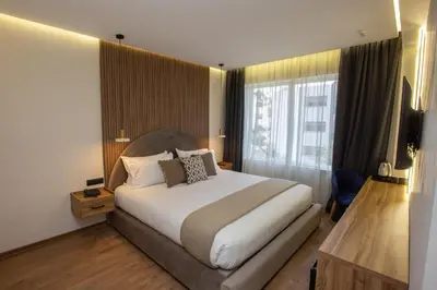 a hotel room with a bed and a large window at Le M Hôtel in Rabat