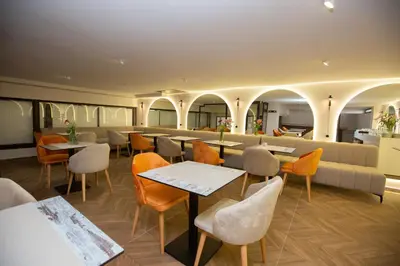 a restaurant with tables and chairs and a couch at Le M Hôtel in Rabat