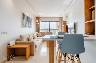 a living room with a couch and a table at StayInn - Studio luxueux & cosy avec terrasse aménagée in Casablanca