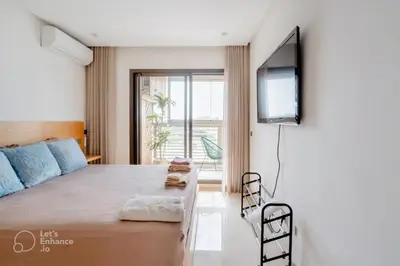 a bedroom with a bed and a flat screen tv at StayInn - Studio luxueux & cosy avec terrasse aménagée in Casablanca