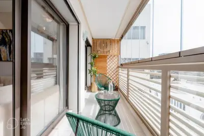 a balcony with a green chair and a table at StayInn - Studio luxueux & cosy avec terrasse aménagée in Casablanca