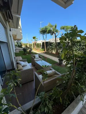 a patio with couches and a table on a house at CASA BAY BEACH OMK 2 in Sidi Rahal