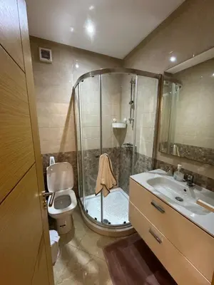 a bathroom with a shower and a toilet and a sink at CASA BAY BEACH OMK 2 in Sidi Rahal