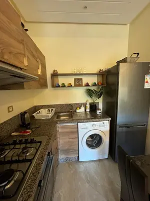a kitchen with a washing machine and a sink at CASA BAY BEACH OMK 2 in Sidi Rahal
