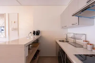 a kitchen with white cabinets and a sink at Chez Joe - Location journalière Casablanca in Casablanca
