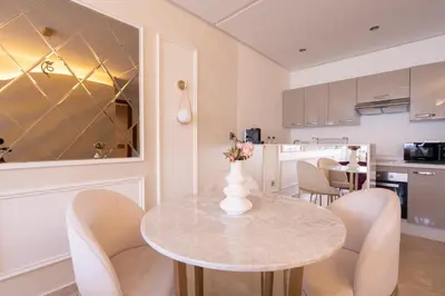 a kitchen and dining room with a table and chairs at Chez Joe - Location journalière Casablanca in Casablanca