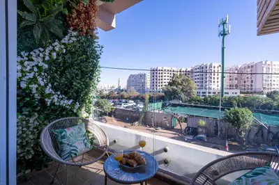a balcony with a table and chairs with a view at Chez Joe - Location journalière Casablanca in Casablanca