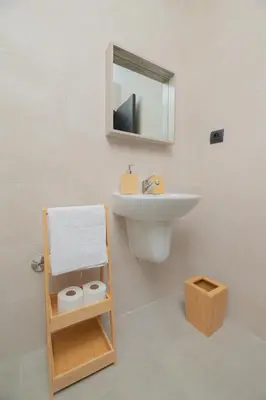 a white bathroom with a sink and a mirror at TheCasaEdition Gauthier Residency City Center in Casablanca