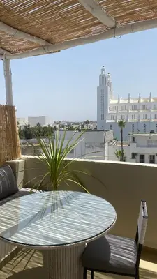 a table and chairs on a balcony with a view at TheCasaEdition Gauthier Residency City Center in Casablanca