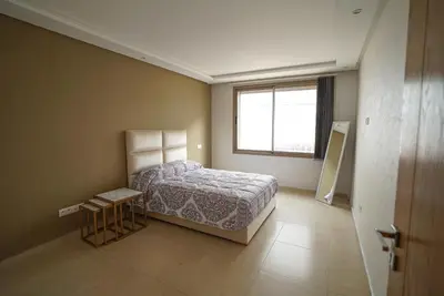 a bedroom with a bed and a window at New Appartment in Rabat