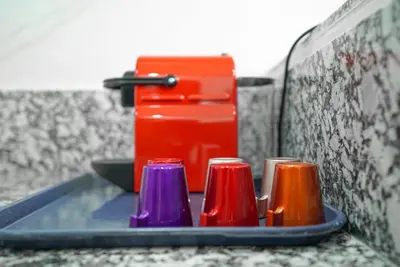 a tray with different colored cups on a counter at New Appartment in Rabat