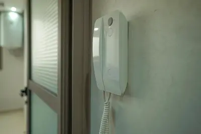 a phone hanging on a wall next to a door at New Appartment in Rabat