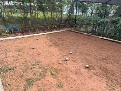 a bunch of balls sitting on a dirt field at Maison de Campagne in Dar SaÃ¯d Ben Hajj