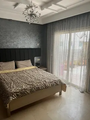 a bedroom with a large bed and a chandelier at Luxury apartments 3 in Casablanca