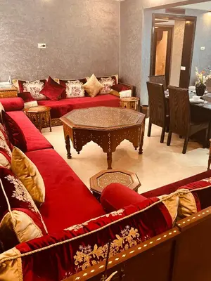 a living room with red couches and a table at Luxury apartments 3 in Casablanca