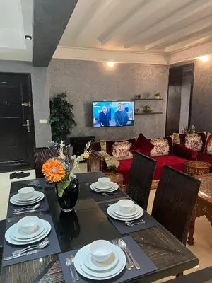 a dining room with a table and a couch at Luxury apartments 3 in Casablanca